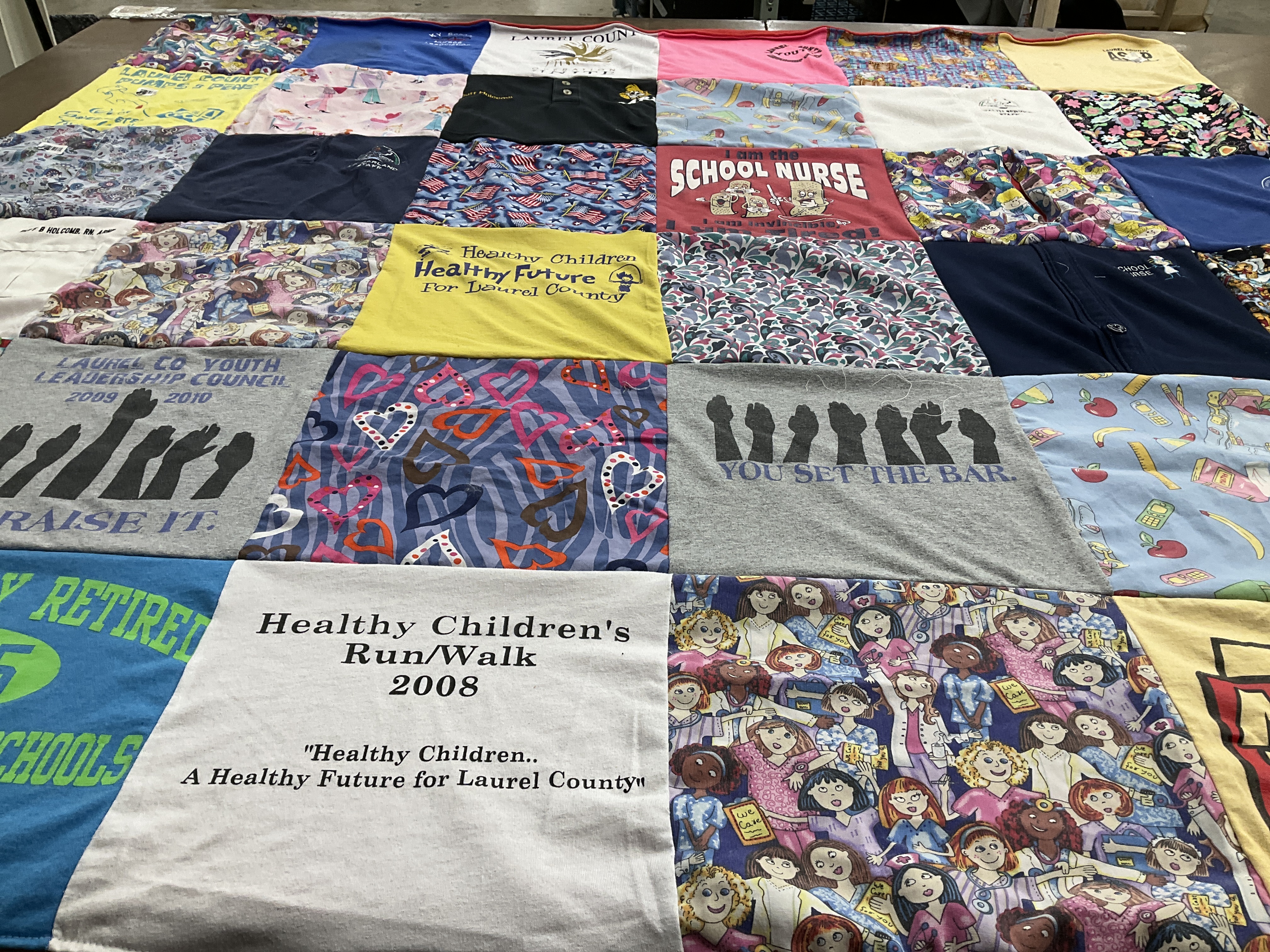 T-shirt quilt with community health, youth leadership themes by duff from KY