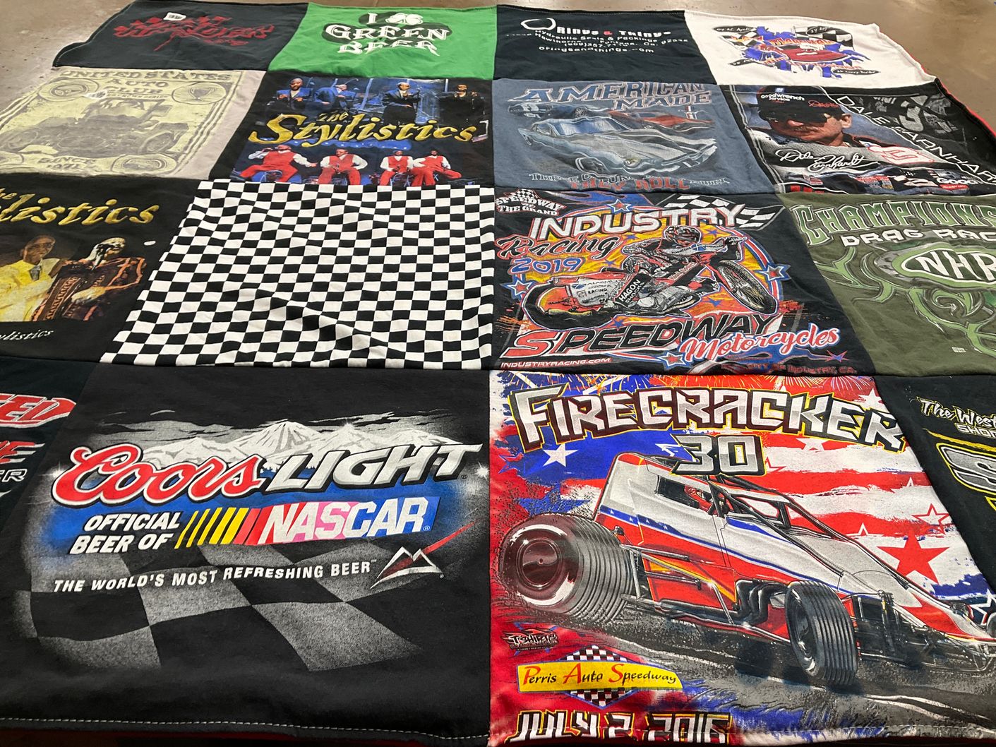 T-shirt quilt with nascar, music themes by Kathy from CA