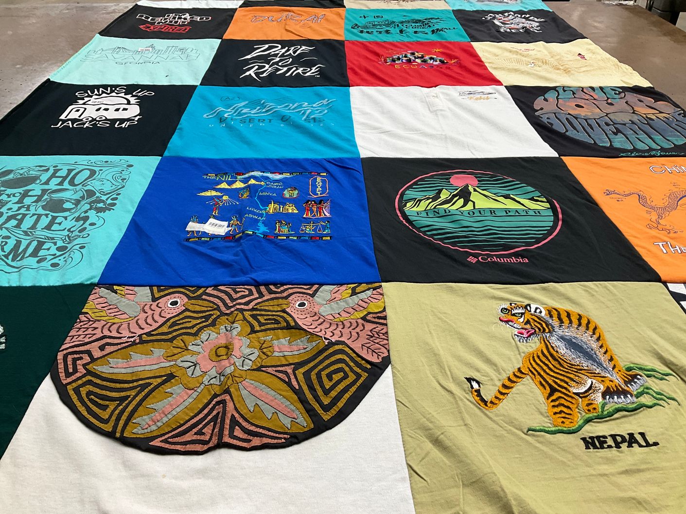 T-shirt quilt with adventure, travel themes by Karen from AZ