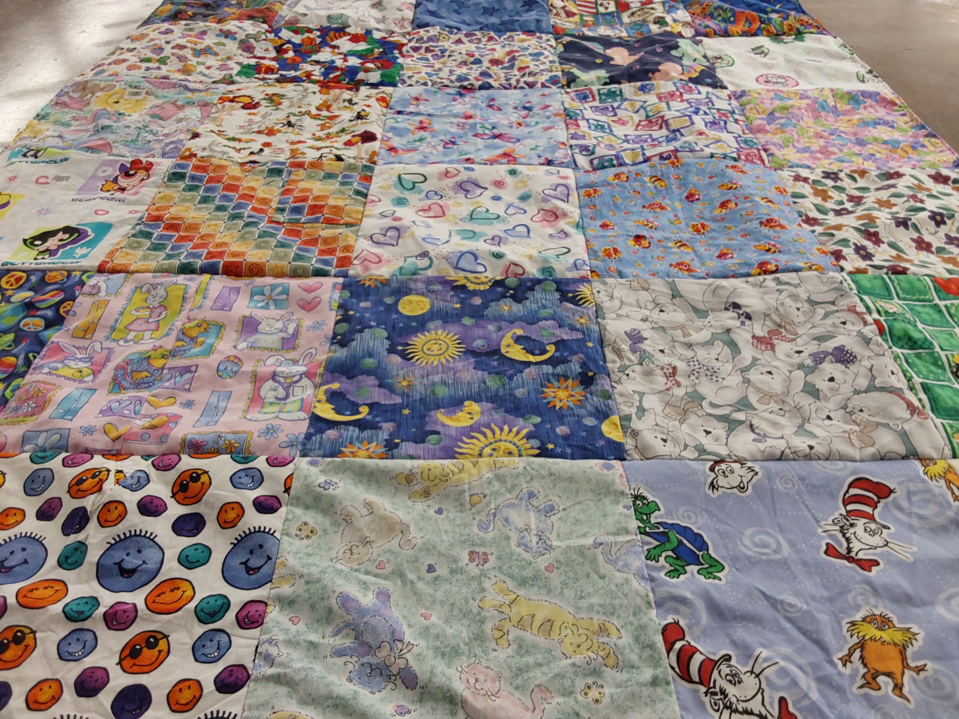 T-shirt quilt with cartoons, animals themes by Susan from NJ