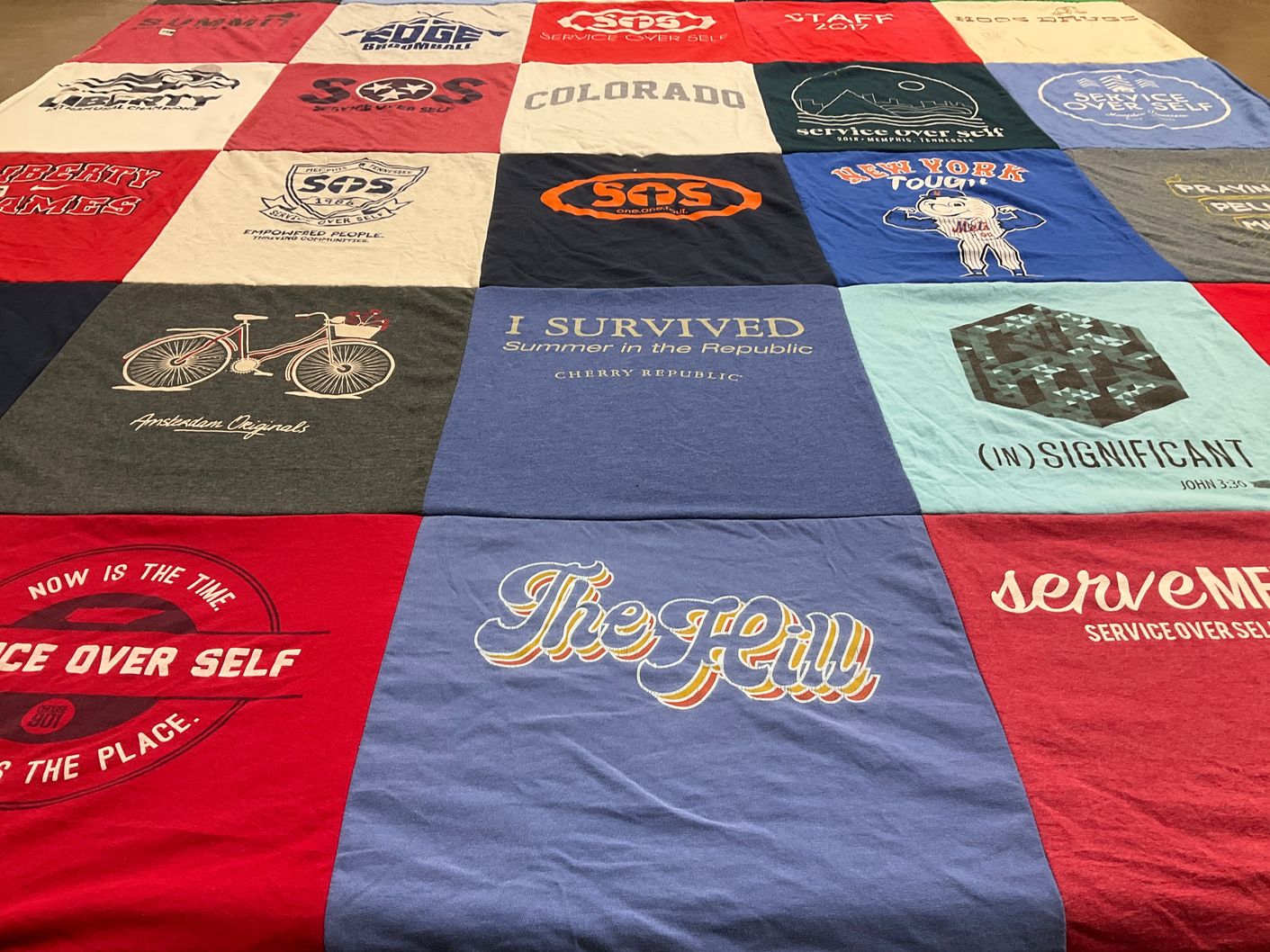 T-shirt quilt with service, community themes by Joy from MI