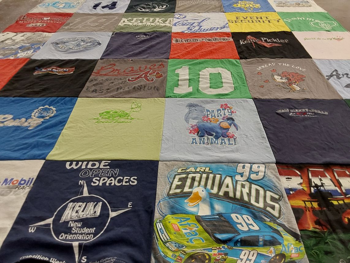 T-shirt quilt with nascar, music themes by Kim from NY
