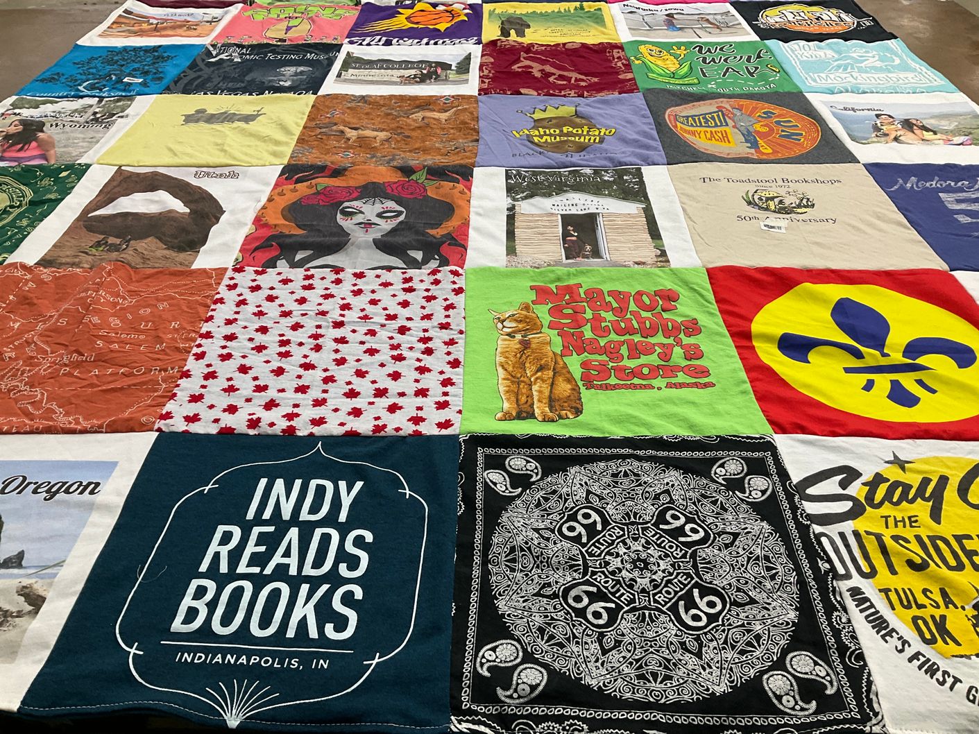 T-shirt quilt with reading, travel themes by Ruchi from NY