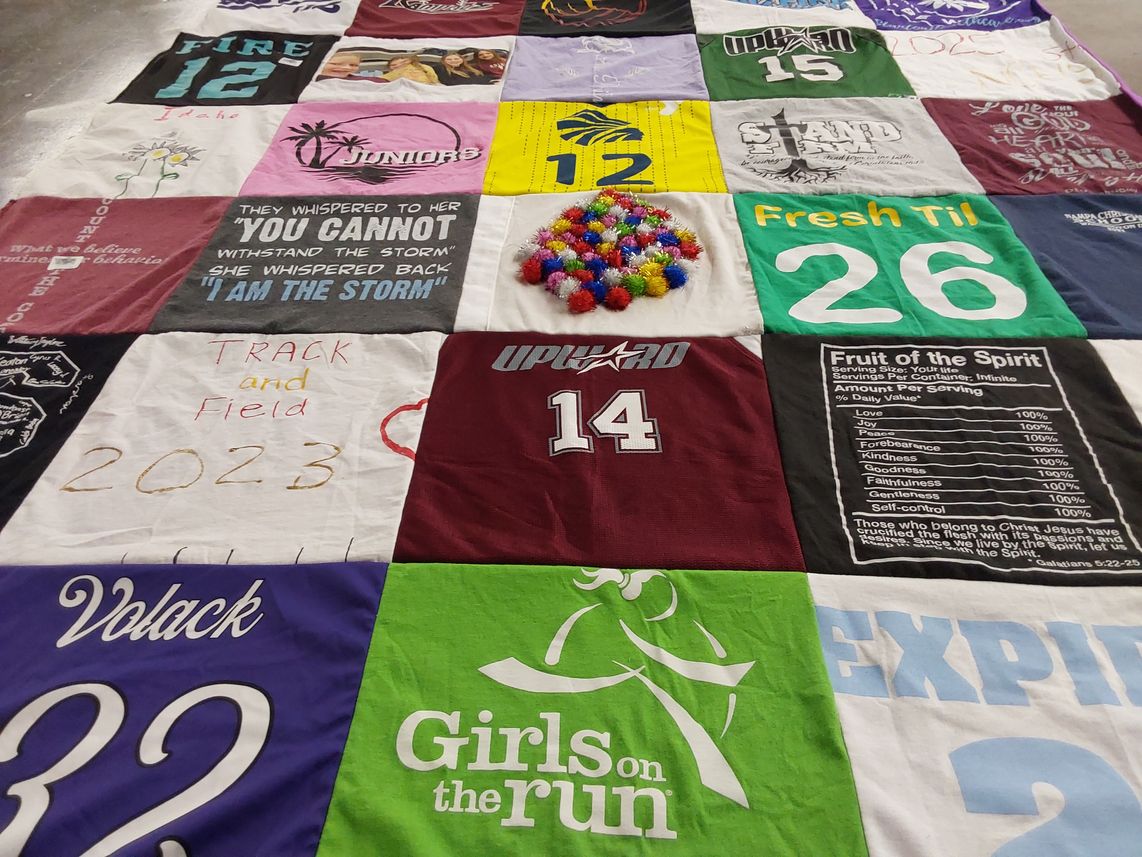T-shirt quilt with track and field, community service themes by Heather from ID