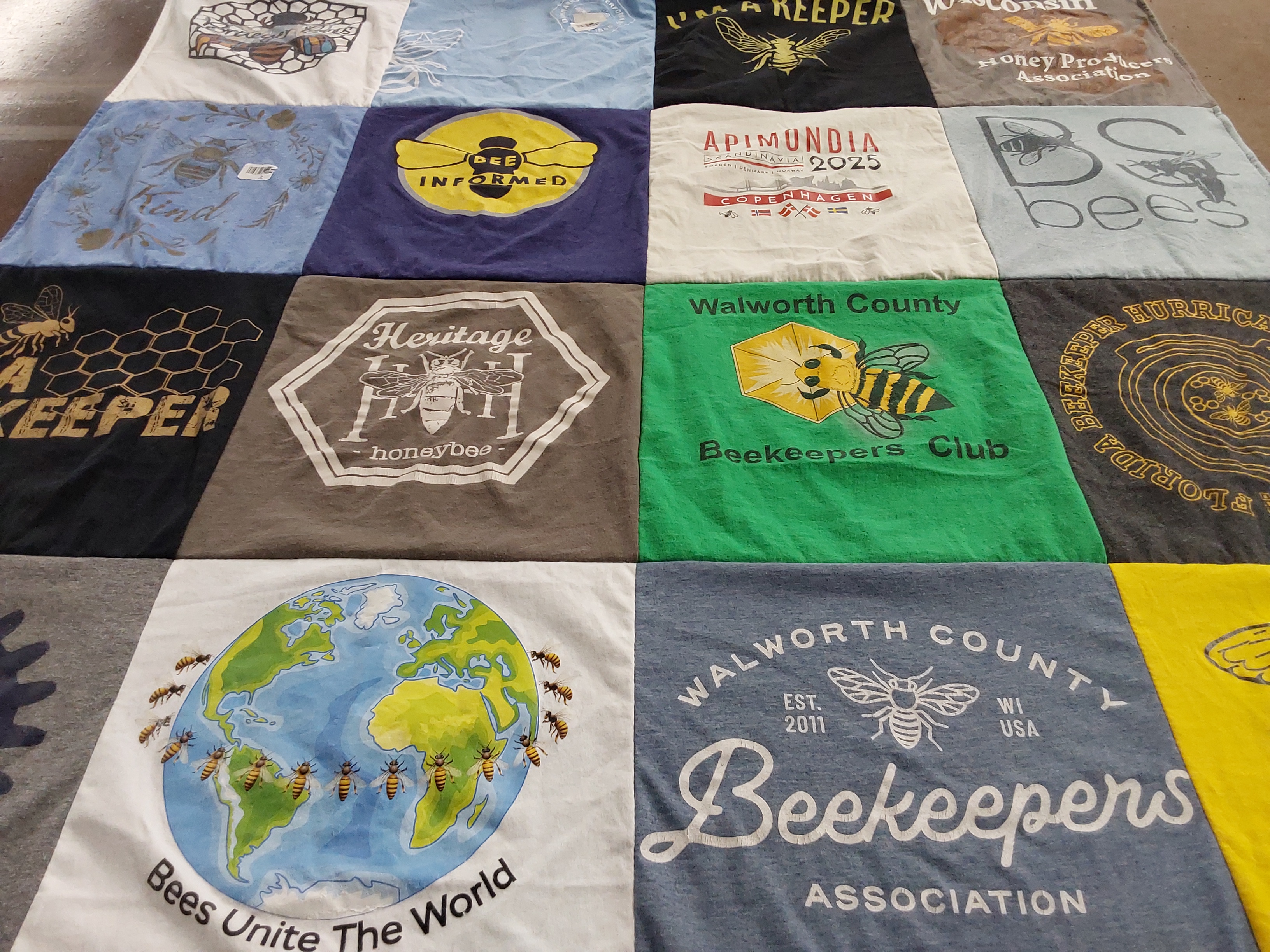 T-shirt quilt with beekeeping, environmental awareness themes by Jess from WI