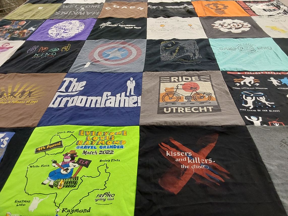 T-shirt quilt with cycling, choir themes by Mitchell from CA