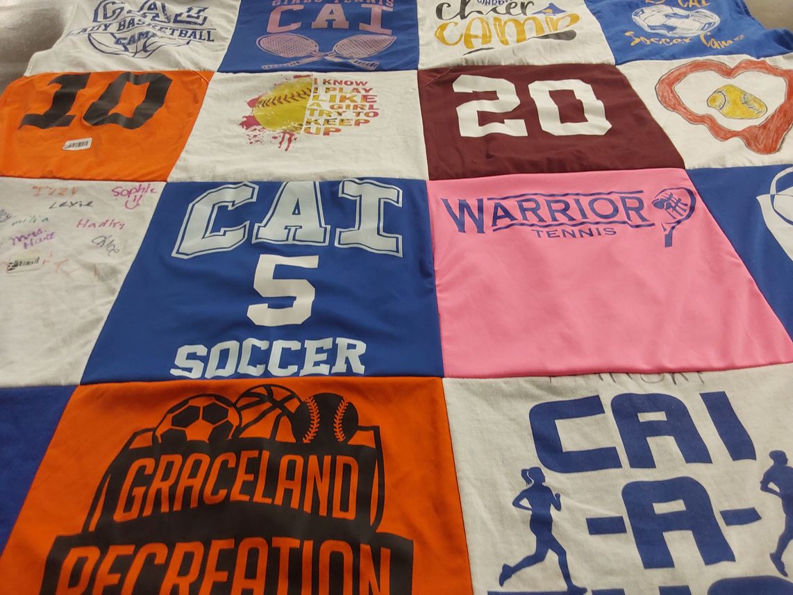 T-shirt quilt with sports, camp themes by Julie from IN