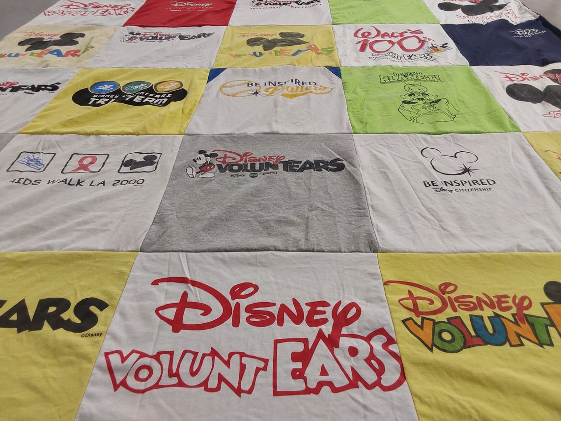 T-shirt quilt with disney, volunteering themes by Laura from CA