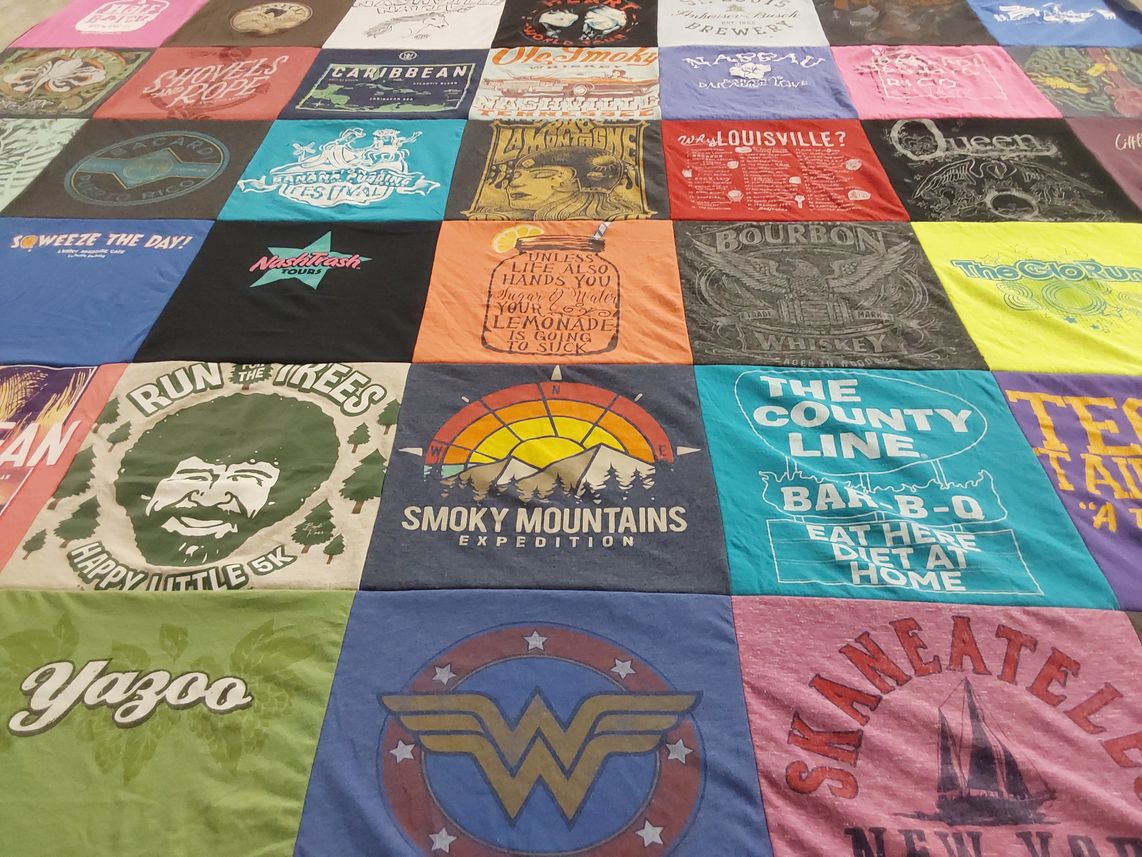 T-shirt quilt with outdoor activities, whiskey tasting themes by Heather from TN