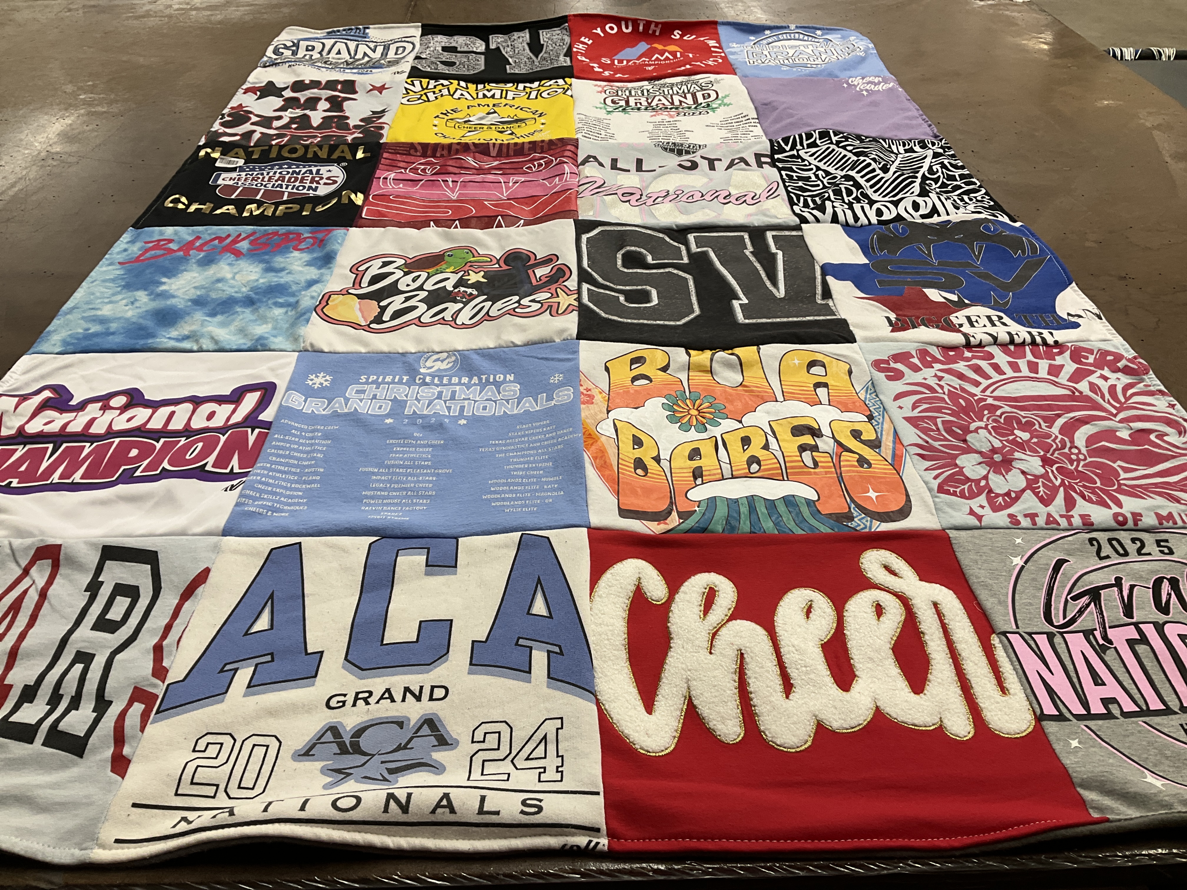 T-shirt quilt with cheerleading, sports themes by Kelley from TX