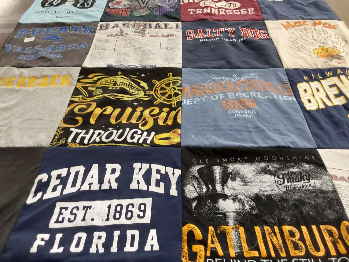 T-shirt quilt with travel, beverages themes by DEBORAH from WI