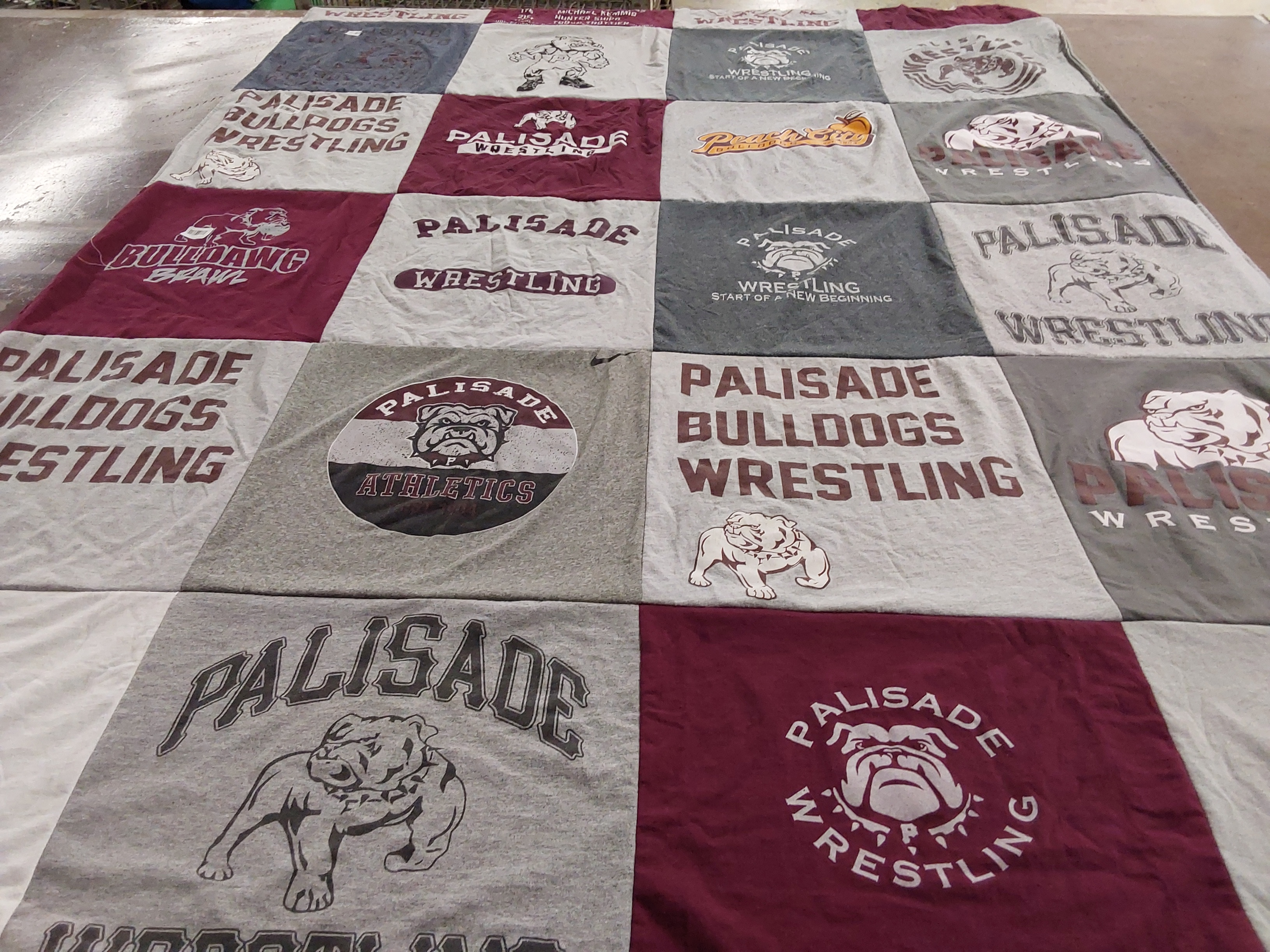 T-shirt quilt featuring palisade bulldogs wrestling by Marina from CO