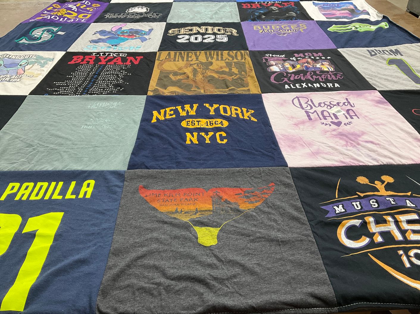 T-shirt quilt with cheerleading, music themes by Jessica from TX