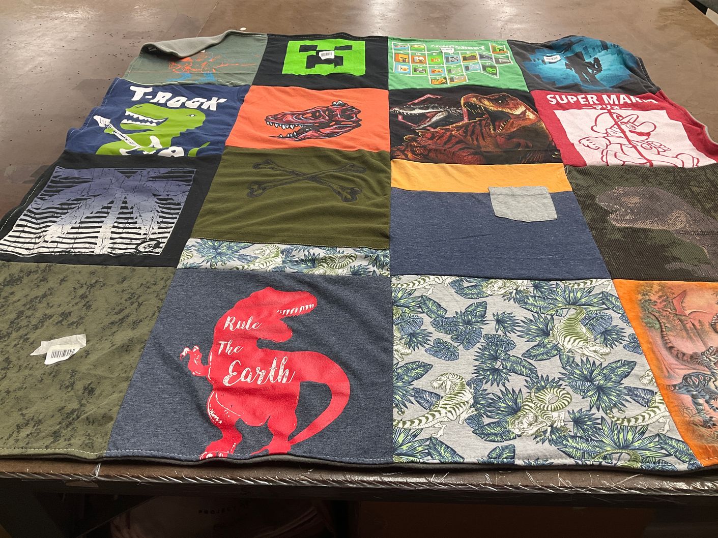 T-shirt quilt with dinosaurs, video games themes by Heather from TX