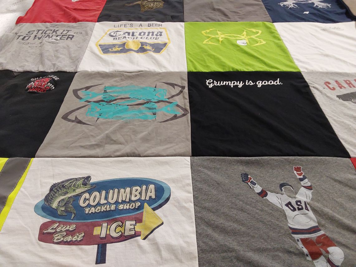 T-shirt quilt with fishing, hockey themes by Cheryl from MN