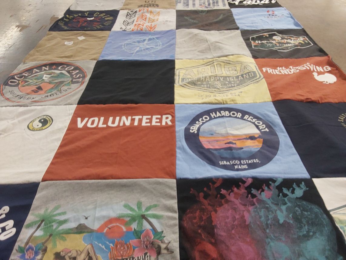 T-shirt quilt with travel, volunteering themes by Jennifer from MA