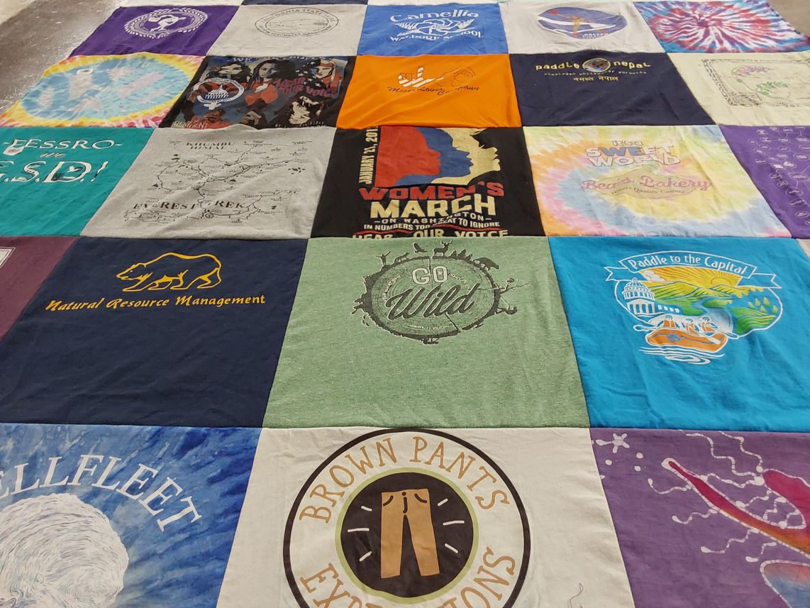 T-shirt quilt with environmentalism, yoga themes by Terri from CA