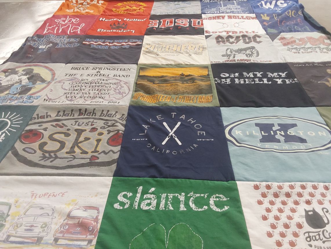T-shirt quilt with skiing, music themes by Carol from CA