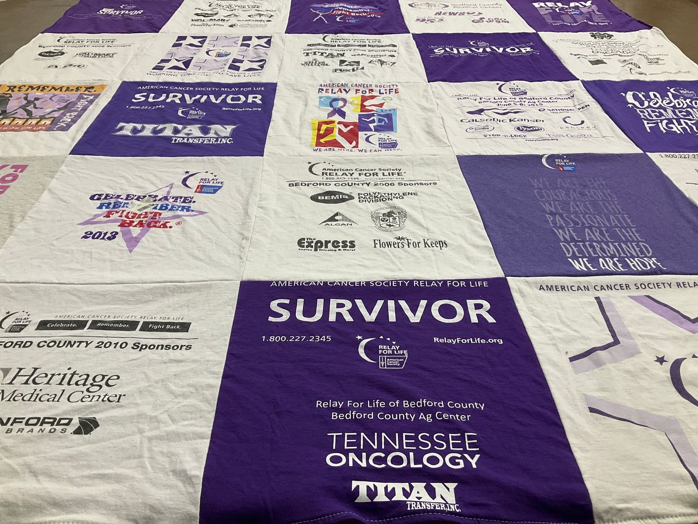 T-shirt quilt with cancer awareness, community support themes by MARY from TN