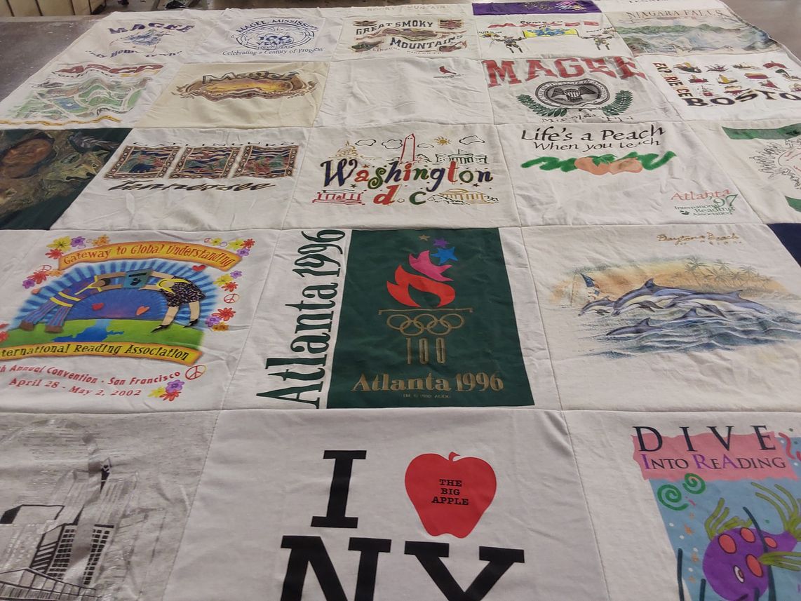T-shirt quilt with travel, reading themes by Carrie from TN