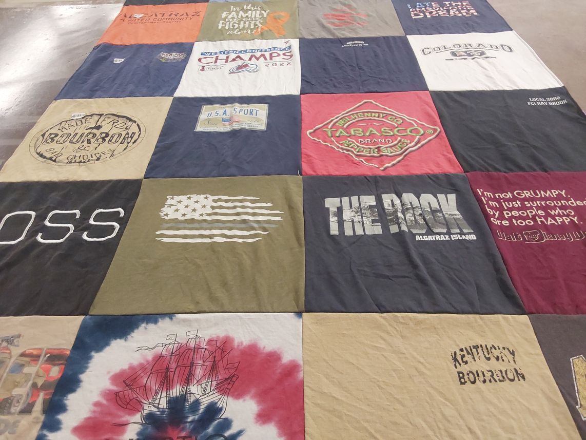 T-shirt quilt with bourbon, sports themes by Theresa from NY