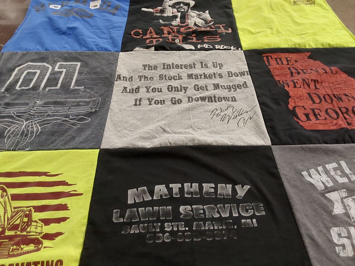 T-shirt quilt with lawn care, stock market themes by Shannon from MI