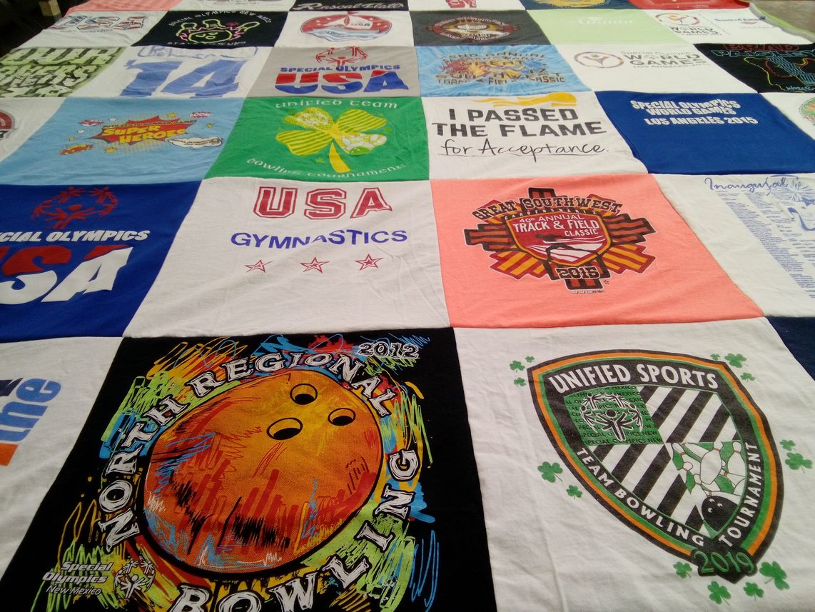 T-shirt quilt with sports, acceptance themes by Betty from NM