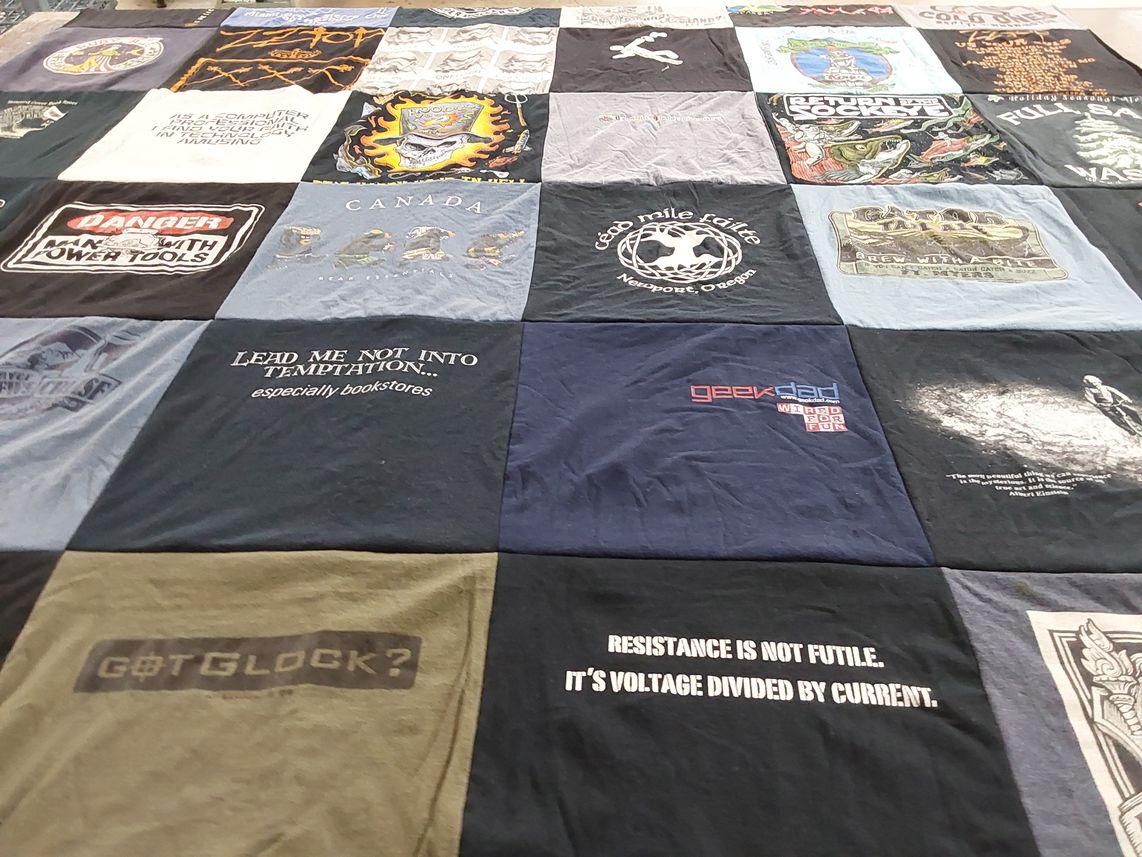 T-shirt quilt with books, technology themes by evonne from OH