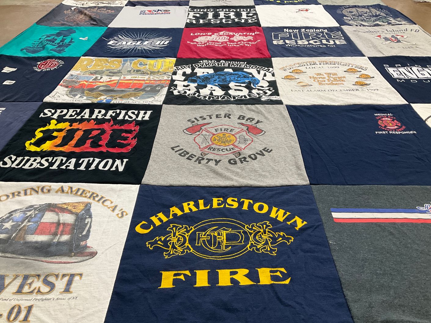 T-shirt quilt with firefighting, community service themes by Liz from WI