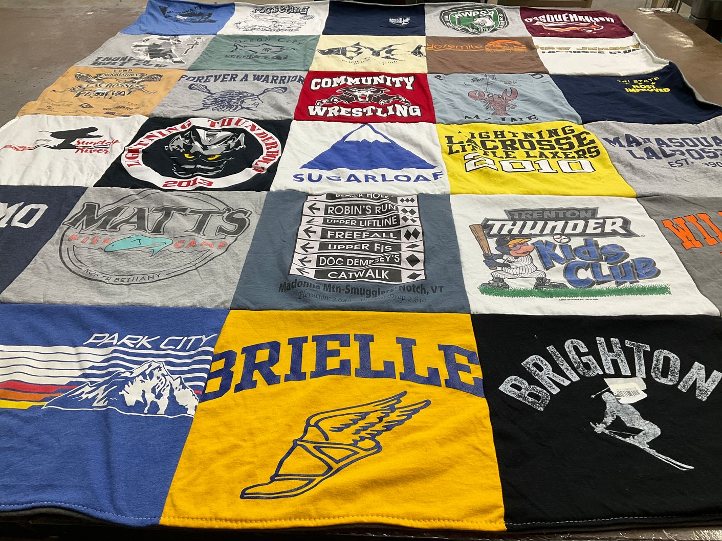 T-shirt quilt with fishing, sports themes by Linda from NJ