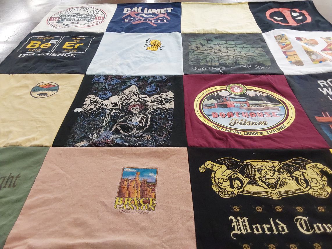 T-shirt quilt with national parks, beer themes by Jayne from WI