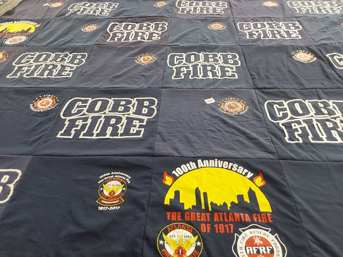 T-shirt quilt with firefighting, community service themes by Kim from GA