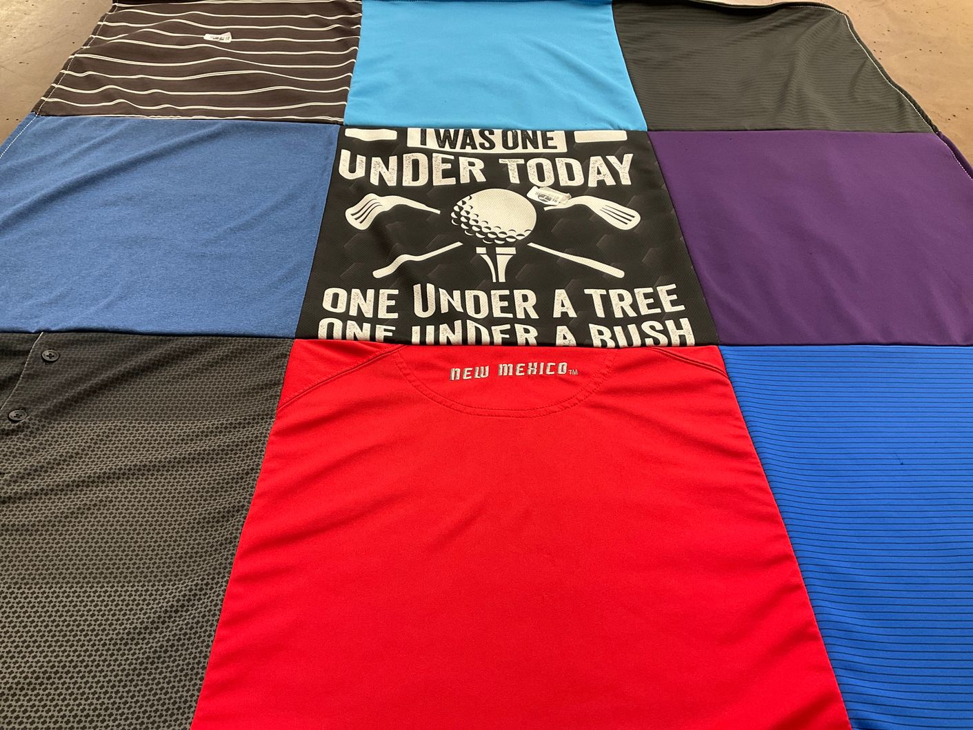 T-shirt quilt with golf themes by Rivers, from NM
