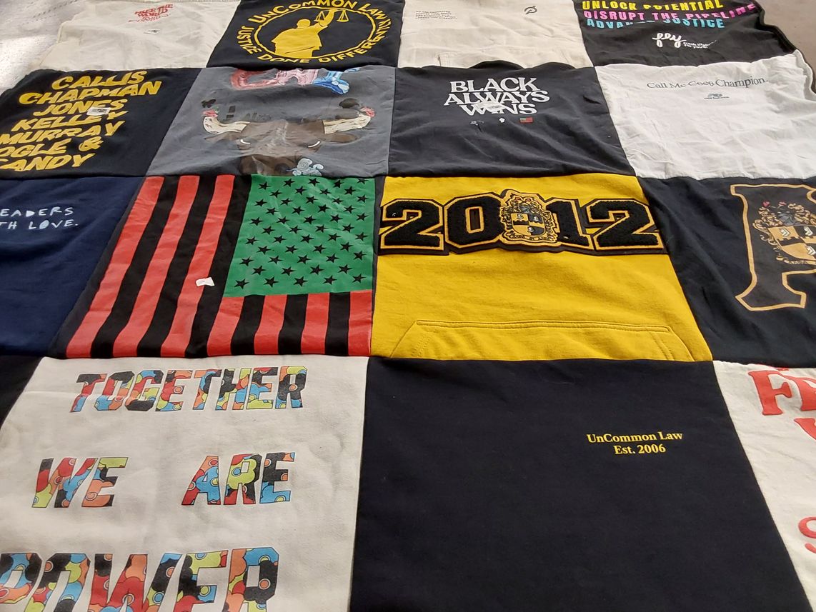 T-shirt quilt with social justice, community empowerment themes by Ernest from CA