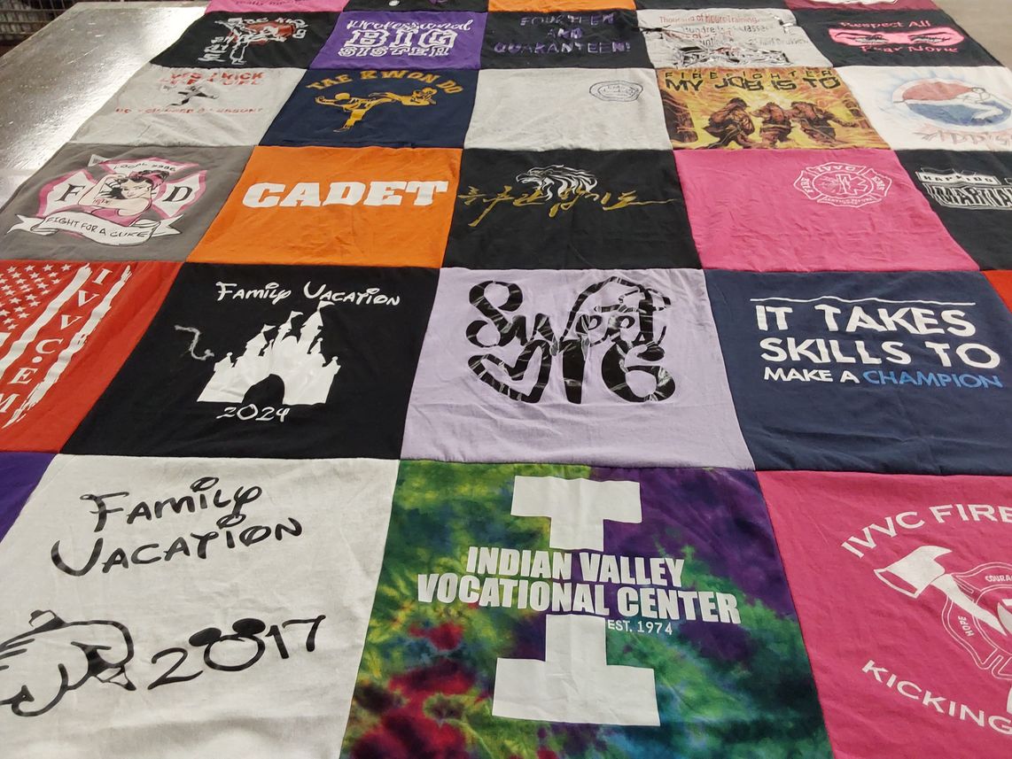 T-shirt quilt with family trips, cooking themes by Amanda from IL