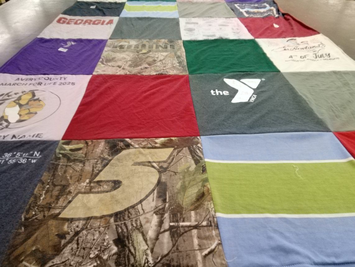 T-shirt quilt with events, community themes by Gail from NC