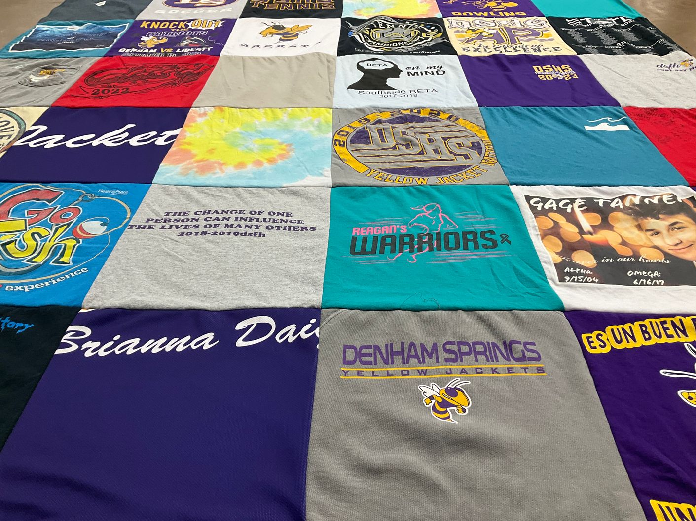 T-shirt quilt featuring reagan's warriors, denham springs yellow jackets by Christi daigle from LA