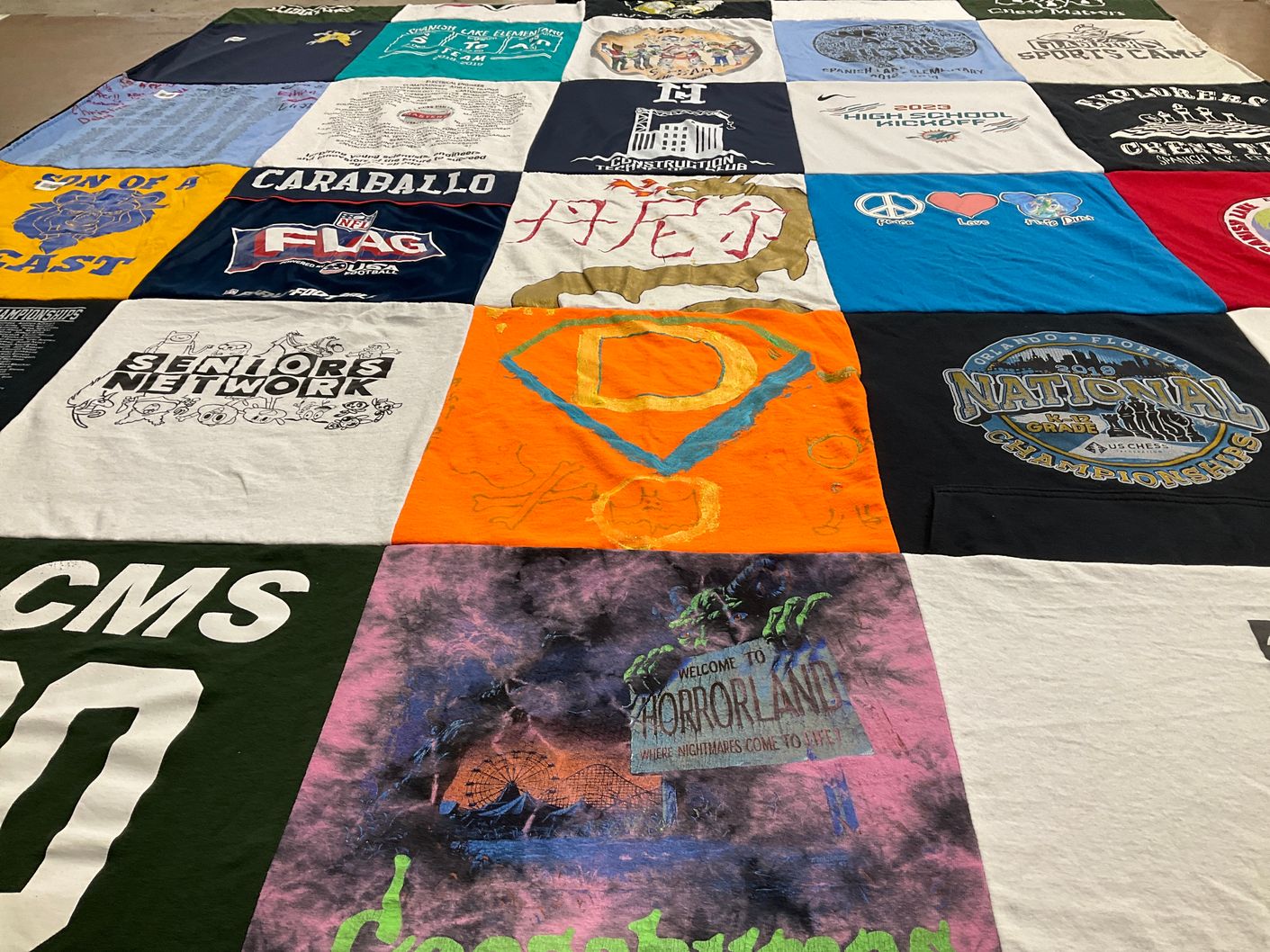 T-shirt quilt with flag football, chess themes by Lesley from FL