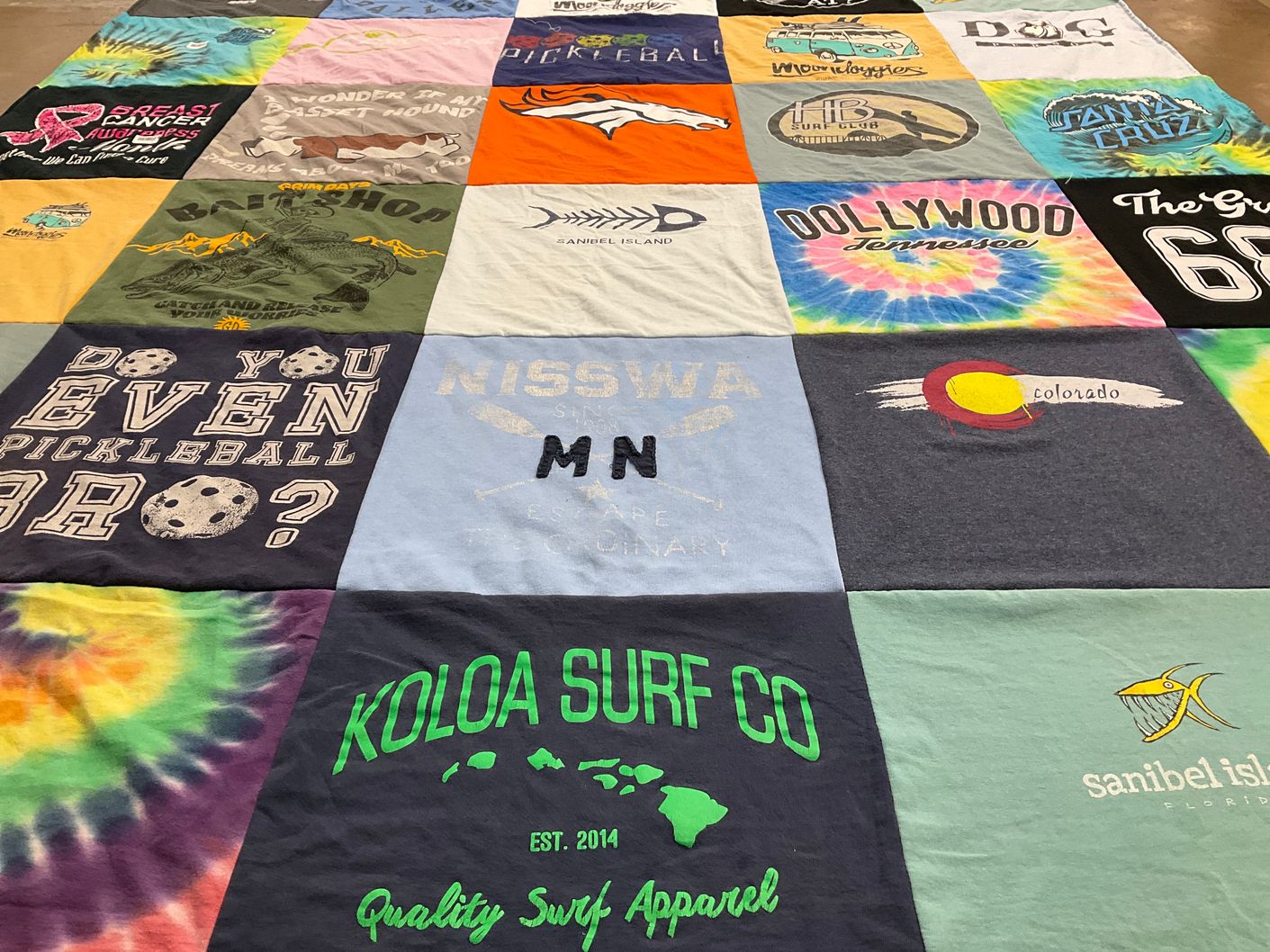 T-shirt quilt with pickleball, surfing themes by Barbara from CA