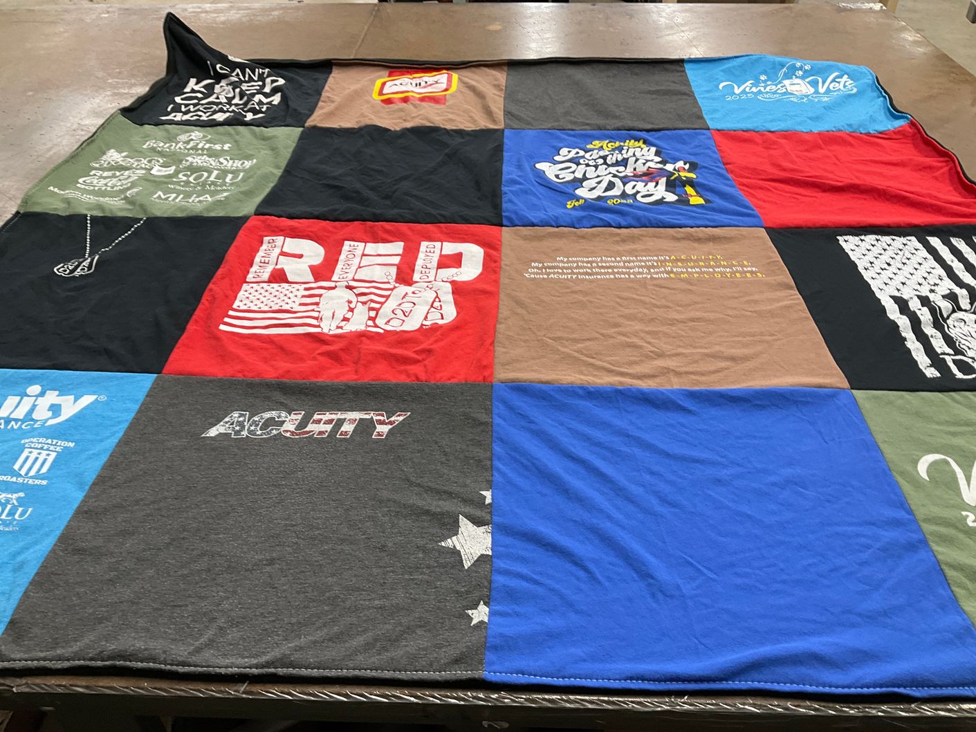 T-shirt quilt with veterans, insurance themes by Mary from WI