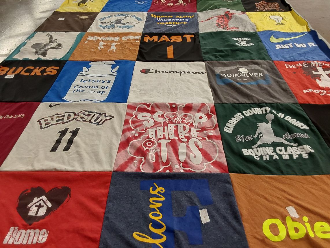 T-shirt quilt with sports, community events themes by Mary from IN