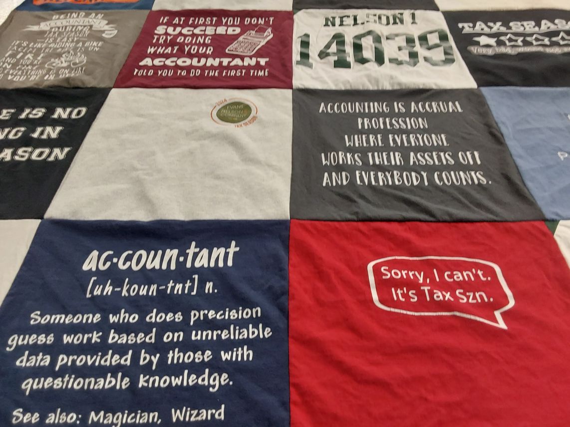 T-shirt quilt with accounting, taxation themes by Emily from NV