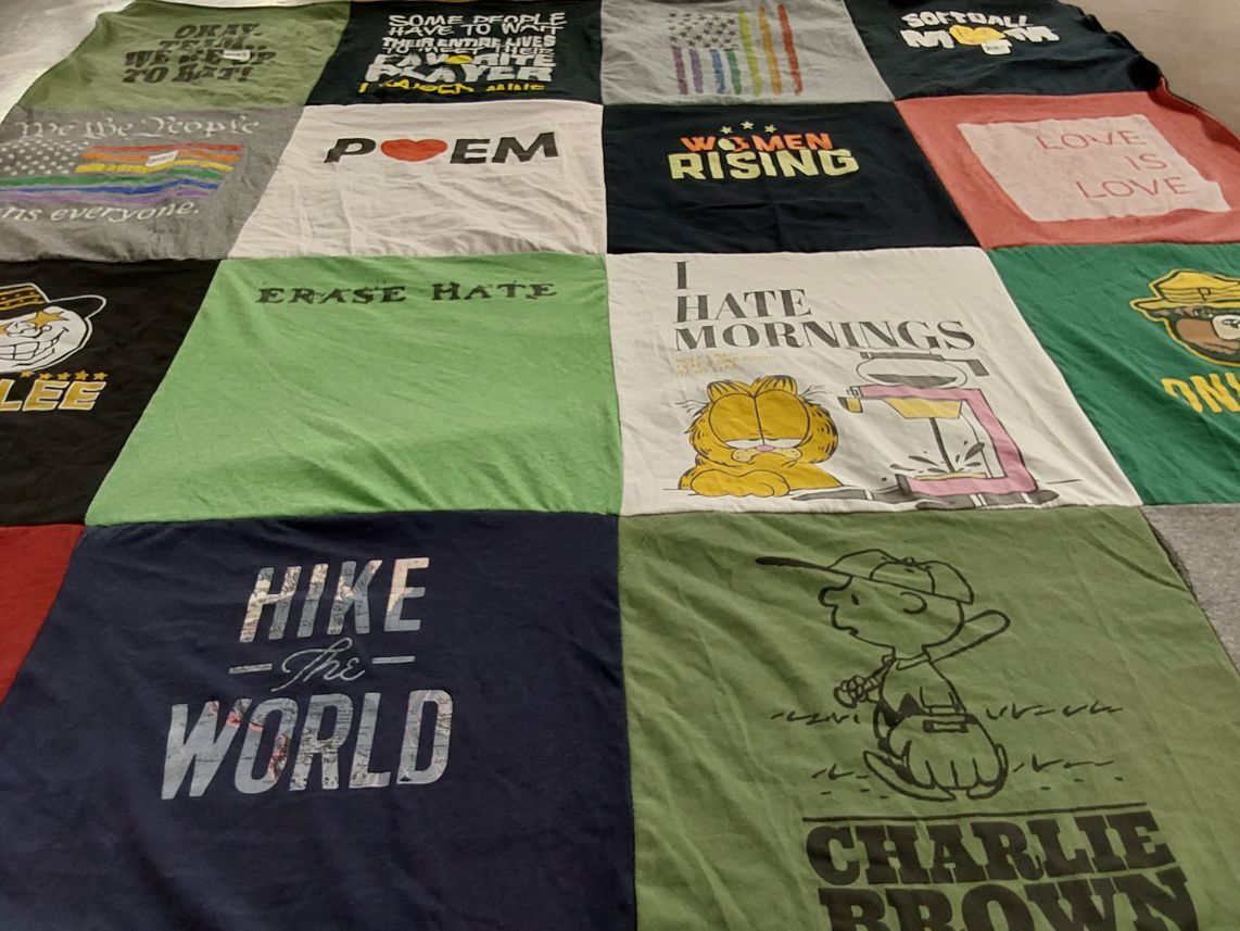 T-shirt quilt with hiking, softball themes by Laura from CO