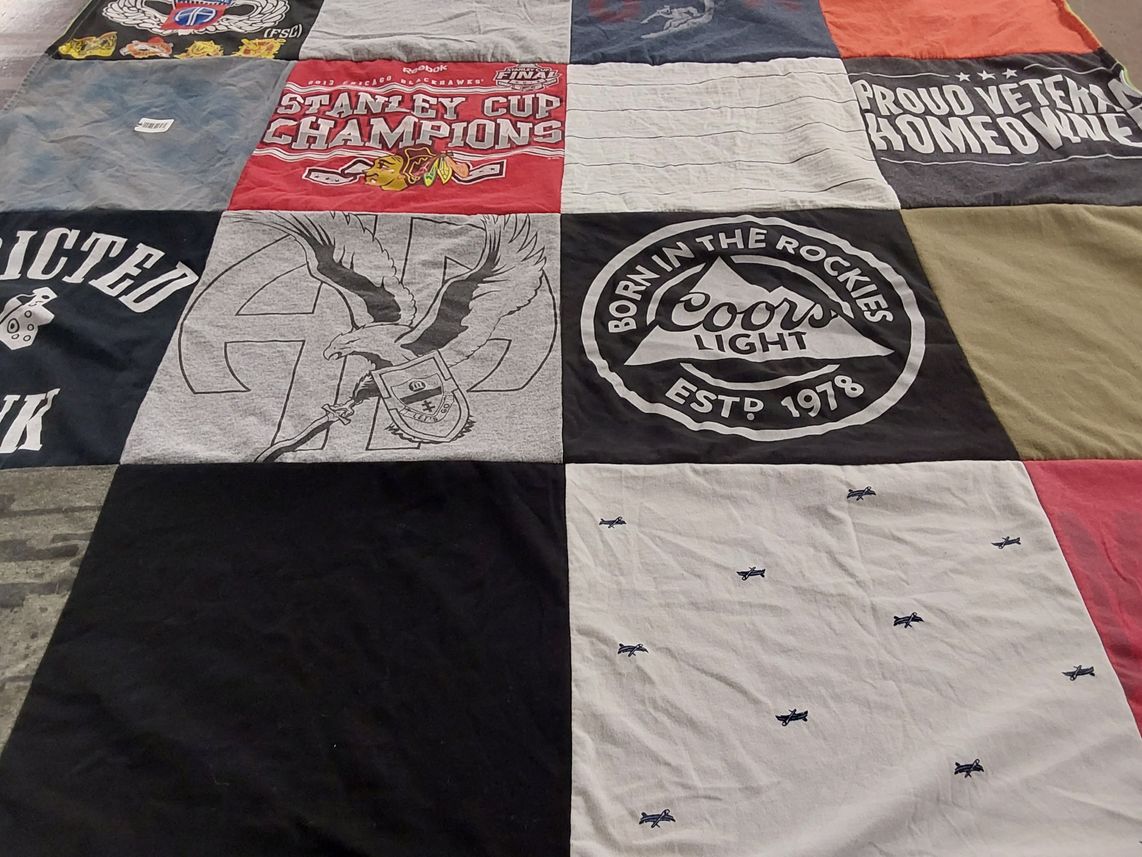 T-shirt quilt with hockey, veterans themes by Laure from IL