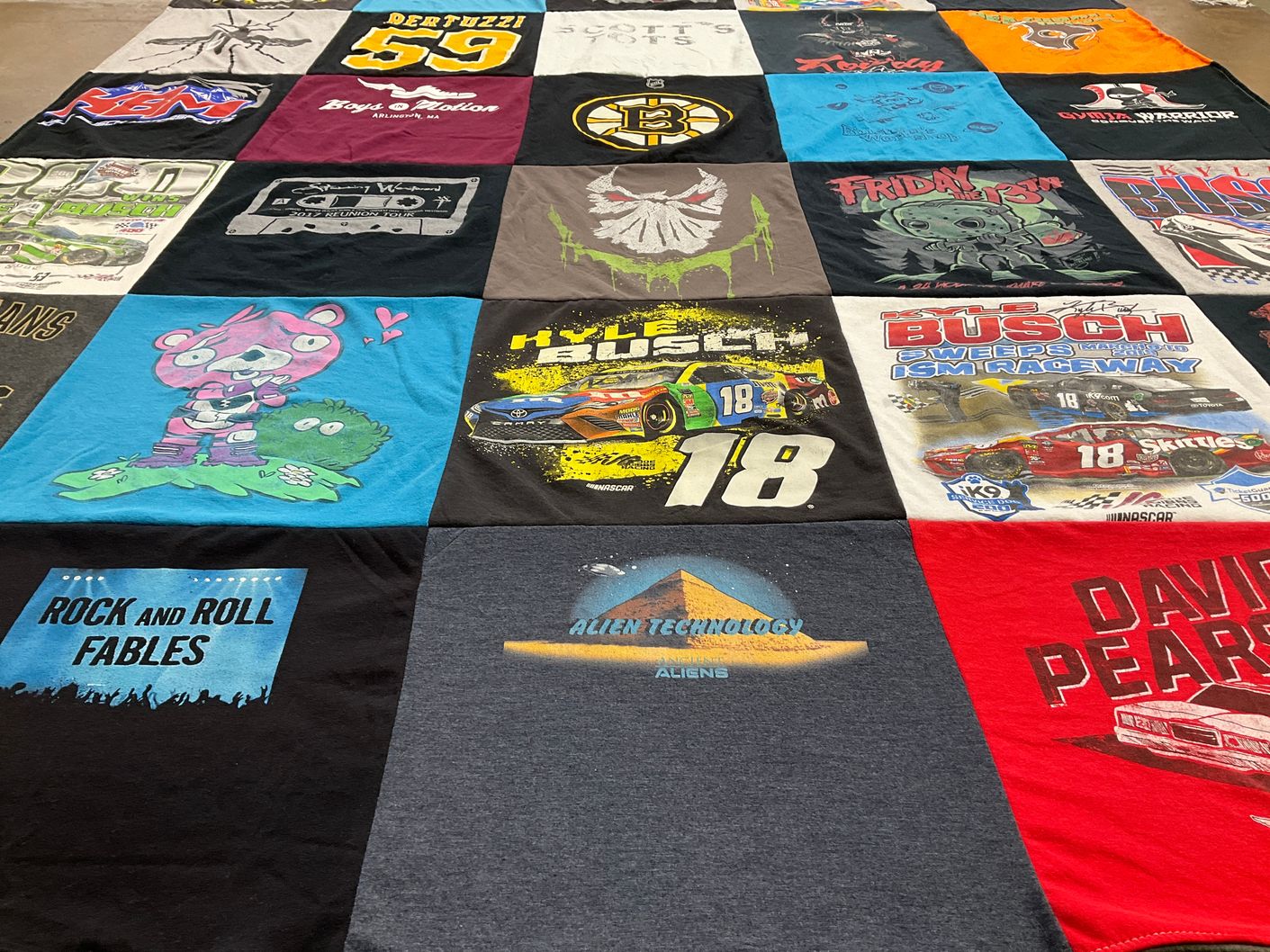 T-shirt quilt with nascar, music themes by Regina from MA