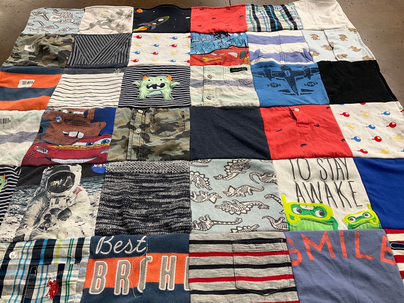 T-shirt quilt with space, dinosaurs themes by L Tyler from UT