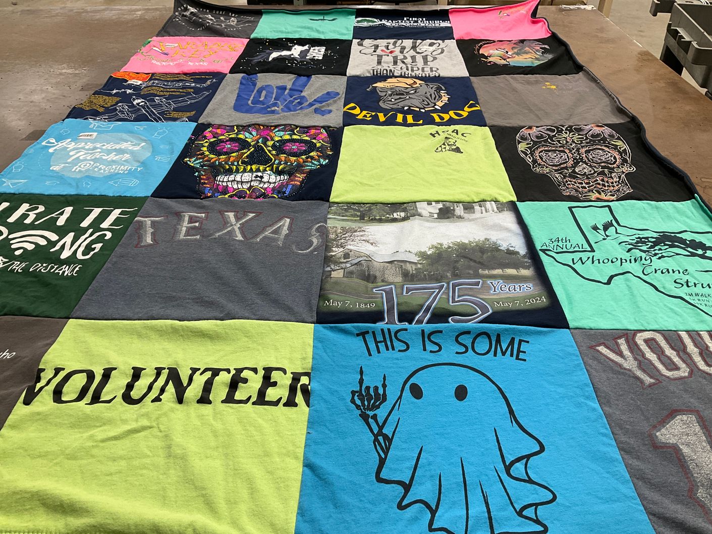 T-shirt quilt with volunteering, travel themes by Eve from TX