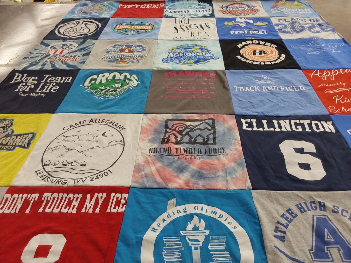 T-shirt quilt featuring crocs swim team by Megan from VA