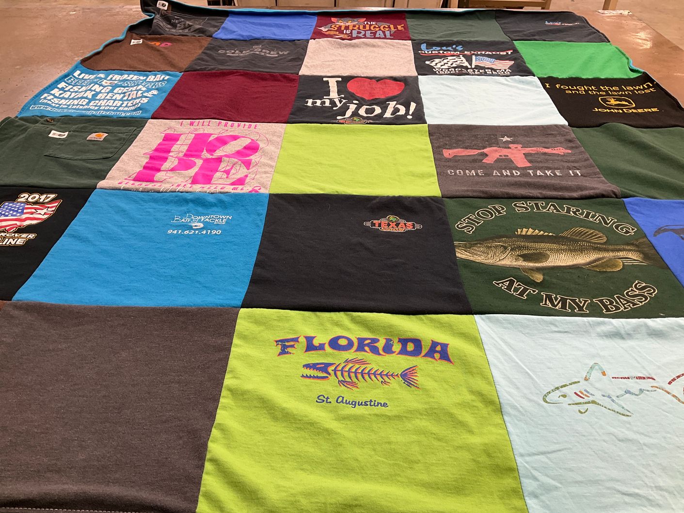 T-shirt quilt with fishing, hunting themes by Catherine from FL