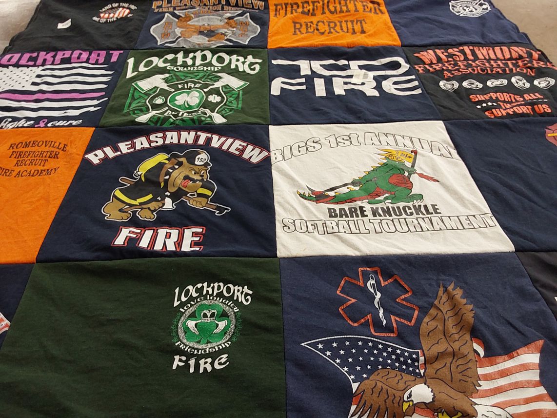 T-shirt quilt with firefighting, community events themes by Jenny from IL